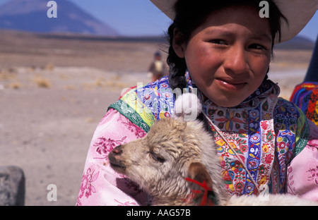 Young Quechua girl from the Colca valley near Chivay with a lamb Southern Peru South America Stock Photo