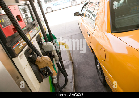 Filling up a yellow cab at a gas station in Harlem New York City USA ...