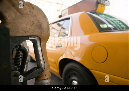 Filling up a yellow cab at a gas station in Harlem New York City USA ...
