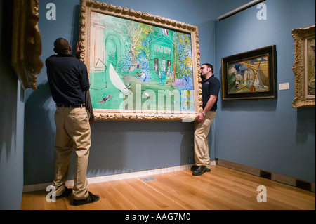 Workers hang Raoul Duffy painting on a wall at Sotheby s New York City US April 2006 Stock Photo