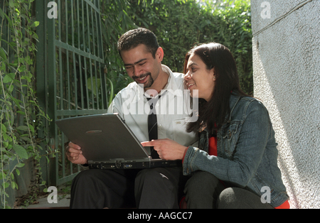 Executives working on a laptop Delhi India Stock Photo