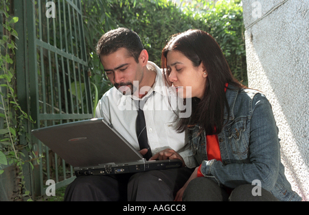 Executives working on a laptop Delhi India Stock Photo