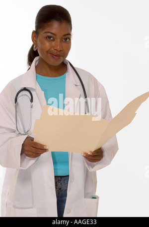 Smiling African American female general practitioner holding patient folder in medical office, USA. Stock Photo