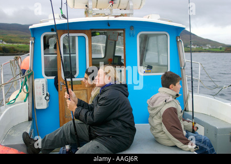 a mother and her two sons on a fishing trip by boat off the Sleave Leagues in County Donegal in Ireland Stock Photo