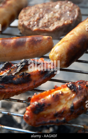 Barbecue barbecued bbq flame grill grilled fire smoke flavour coal charcoal ash food poisoning sausage beef burger beef burger b Stock Photo