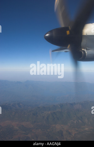 Myanmar Burma Local airline propeller aircraft view from inside aircraft of propeller and landscape during flight Stock Photo