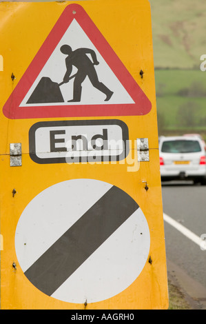 end of roadworks and speed restriction sign on a road in Cumbria, UK Stock Photo