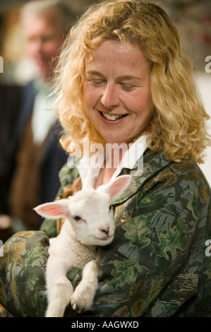 a farmers wife with an orphaned lamb Stock Photo