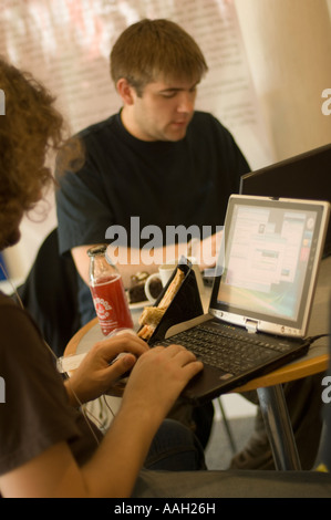Two male students working on laptop computers wireless network Aberystwyth University Wales UK Stock Photo