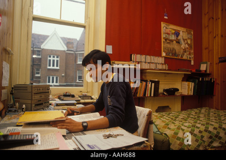 Student Asian doctor in his room studying for his exams South London England. UK 1990s circa 1995 HOMER SYKES Stock Photo