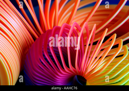 Rainbow colored plastic slinky toys Stock Photo