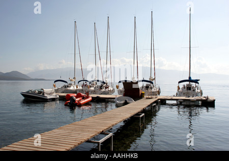 Boats moored on a Jetty at a Sunsail resort in Lefkas in Greece Stock Photo