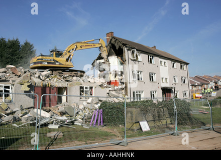 demolition. A bulldozer demolishing old council houses in Ley Hill, Northfield, Birmingham, England. Stock Photo