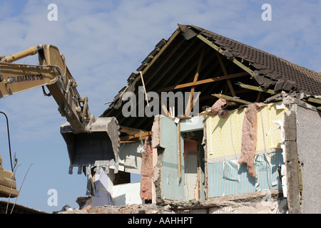 A bulldozer demolishing old council houses in Ley Hill, Northfield, Birmingham, England. Stock Photo
