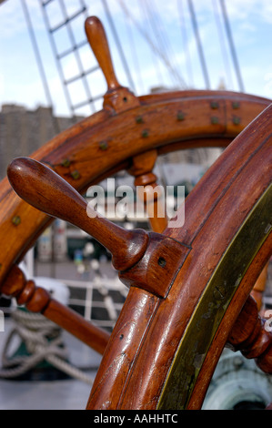 A detail of a wooden ships captains steering wheel as part of an old wooden sailing ship. Stock Photo