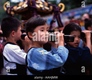 Japanese children carrying portable shrine at Tokyo's Sanja Matsuri held at Senso-ji Temple (Asakusa Kannon ) Stock Photo