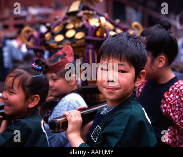 Japanese children carrying portable shrine at Tokyo's Sanja Matsuri held at Senso-ji Temple (Asakusa Kannon ) Stock Photo