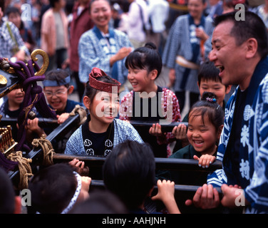 Japanese children carrying portable shrine at Tokyo's Sanja Matsuri held at Senso-ji Temple (Asakusa Kannon ) Stock Photo