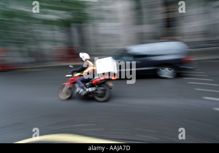 Motor cycle messenger courier in London Stock Photo