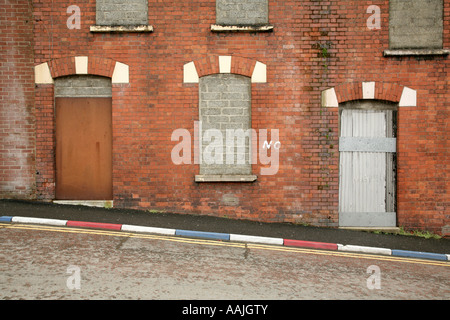 Boarded up housing in Wapping Lane in The Fountain estate, Londonderry, County Derry, Northern Ireland. Stock Photo