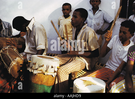 Swahili boys playing drums for traditional celebration of Festival of the Prophet s Birthday Lamu Island Kenya Stock Photo