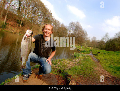 Fly fishing at Robins Lake in Robins Wood Farnham South England Stock Photo