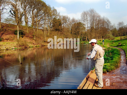 Fly fishing at Robins Lake in Robins Wood Farnham South England Stock Photo