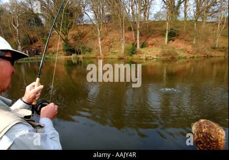 Fly fishing at Robins Lake in Robins Wood Farnham South England Stock Photo