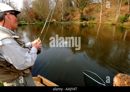 Fly fishing at Robins Lake in Robins Wood Farnham South England Stock Photo