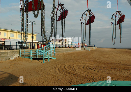 The Funfair carousel seats at dawn Stock Photo