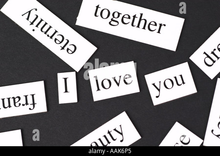 Magnetic fridge words jumbled up but with the words I Love You in the middle Stock Photo