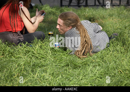 man with long dreadlocks relaxing on the grass Stock Photo
