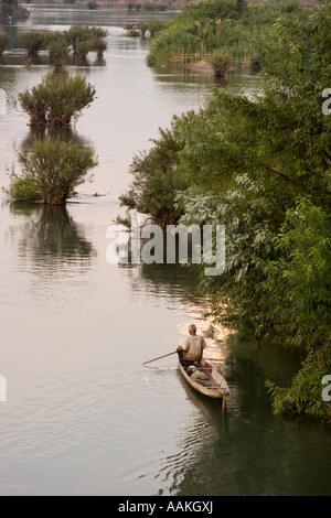 Man rows boat in the Mekong river Don Det Laos Stock Photo