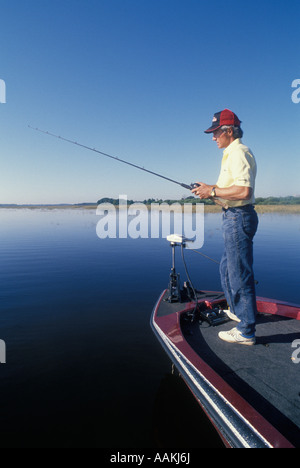 1991 MAN BASS FISHING USING BASS BOAT Stock Photo