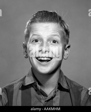 1960s PORTRAIT SMILING WIDE-EYED HAPPY SURPRISED TEENAGE BOY LOOKING AT CAMERA Stock Photo