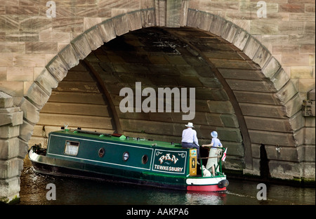 A narrowboat passes under Worcester Bridge on the River Severn in the centre of Worcester UK Stock Photo