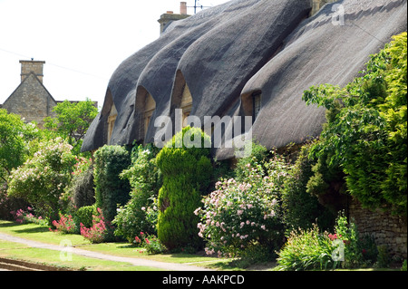 A thatched cottage in the town of Chipping Campden in Gloucestershire UK Stock Photo