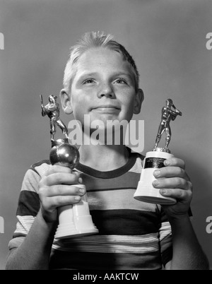 1950s 1960s PROUD BOY HOLDING TWO AWARDS BASEBALL LITTLE LEAGUE TROPHIES TROPHY Stock Photo