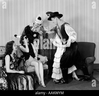 1930s 1940s YOUNG COUPLES DRESSED IN COSTUMES DANCING AT HOME HALLOWEEN PARTY Stock Photo