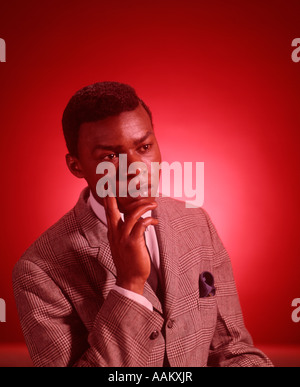 1960s PORTRAIT THOUGHTFUL AFRICAN AMERICAN YOUNG MAN HAND TO CHIN Stock Photo
