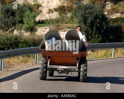 Dumper Truck with Old Oil Drums Sedella Andalucia Spain dump dumper truck trucks Sedella Malaga province Sierra Tejeda campo Stock Photo