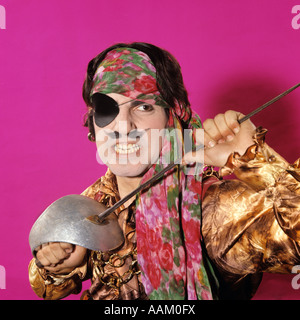 1970s CHARACTER MAN IN PIRATE COSTUME HOLDING A SWORD FUNNY FACE EXPRESSION MOUSTACHE GRITTING TEETH Stock Photo