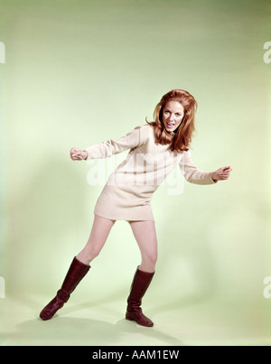 1960s WOMAN DANCER BOOTS TAN MINI-SKIRT DRESS FISHNET STOCKINGS Stock Photo