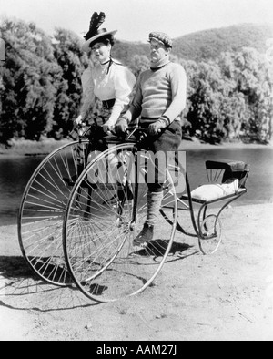 1890s FAMILY RIDING ON UNUSUAL TANDEM BICYCLE WITH BABY IN REAR Stock Photo