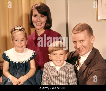 PORTRAIT SMILING FAMILY FATHER MOTHER TWO SONS STANDING TOGETHER IN ...