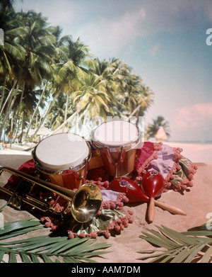 1960 1960s 1970 1970s STILL LIFE MUSICAL INSTRUMENTS CARIBBEAN FLAVOR BONGO DRUM TRUMPET MARACHAS TROPICAL LANDSCAPE Stock Photo
