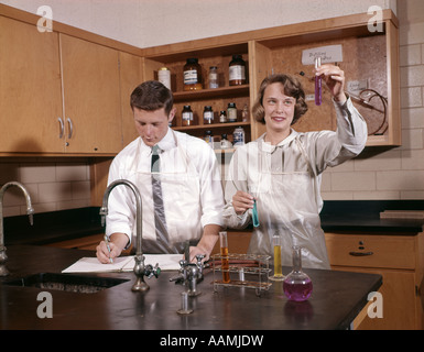 GIRL AND BOY COLLEGE STUDENTS IN SCIENCE LAB Stock Photo