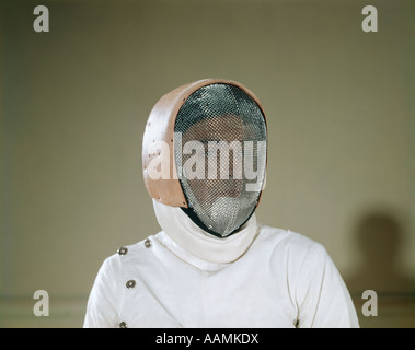1960s MAN FENCER WEARING PROTECTIVE SCREEN MESH MASK IDENTITY BLANK MYSTERY Stock Photo