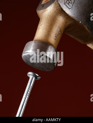 HAMMER HITTING A NAIL Stock Photo