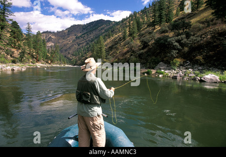 IDAHO Man Fly Fishing from raft Middle Fork of the Salmon River Frank Church Wilderness Stock Photo